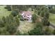 An aerial view of the exterior of the home featuring a deck surrounded by mature trees at 7641 Kelty Trl, Franktown, CO 80116