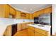 Well-lit kitchen features light-wood cabinetry, stainless steel appliances, and a cooktop island at 7641 Kelty Trl, Franktown, CO 80116
