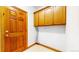Utility room with wooden cabinets and door at 7641 Kelty Trl, Franktown, CO 80116