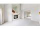 Bright living room featuring an electric fireplace and ample sunlight at 7641 Kelty Trl, Franktown, CO 80116