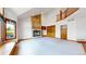 Open-concept living room featuring a stone fireplace and built-in shelves and a bright window at 7641 Kelty Trl, Franktown, CO 80116