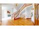 Bright living room featuring wood floors, a chandelier, and a fireplace at 7641 Kelty Trl, Franktown, CO 80116