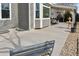 Spacious concrete backyard patio with a seating bench and a view of the backyard fountain at 1168 Coneflower Way, Brighton, CO 80601