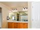 Well-lit primary bathroom with a double sink vanity, a large mirror, and modern lighting fixtures for functional use at 1168 Coneflower Way, Brighton, CO 80601