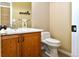 Neat powder bathroom with a single sink vanity, offering a practical and accessible convenience for guests and residents at 1168 Coneflower Way, Brighton, CO 80601