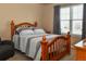 Cozy bedroom with natural light, a wooden bed frame, and a dark gray armchair at 1168 Coneflower Way, Brighton, CO 80601