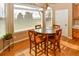 Bright breakfast nook featuring hardwood floors, a round table with seating for four, and large windows at 1168 Coneflower Way, Brighton, CO 80601