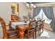 Bright dining room with a chandelier, table with seating for eight, and natural light at 1168 Coneflower Way, Brighton, CO 80601