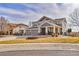 Charming two-story home highlighting a four-car garage, covered porch, and inviting fire pit at 1168 Coneflower Way, Brighton, CO 80601