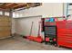 Organized garage with overhead cabinets, tool chests, and wall-mounted storage solutions at 1168 Coneflower Way, Brighton, CO 80601