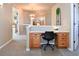 Hallway with a built-in desk area, chandelier, and view to another room at 1168 Coneflower Way, Brighton, CO 80601