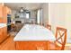 Bright kitchen featuring an extended island with a white countertop and wooden cabinets with eat in kitchen and living space at 1168 Coneflower Way, Brighton, CO 80601