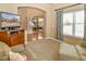 Comfortable living room features neutral carpeting, window with blinds, and flat-screen television at 1168 Coneflower Way, Brighton, CO 80601