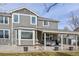 Home featuring a rear exterior view with a patio, fountain, and a well-maintained lawn at 1168 Coneflower Way, Brighton, CO 80601