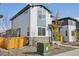 Two-story house with gray and white siding, a wooden fence, and a small front yard at 21021 E 63Rd Dr, Aurora, CO 80019