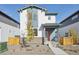 Two-story house with gray and white siding, a red door, and a landscaped front yard at 21021 E 63Rd Dr, Aurora, CO 80019