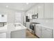 Modern kitchen with light gray cabinets, stainless steel appliances and white countertop at 21021 E 63Rd Dr, Aurora, CO 80019