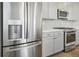 Modern kitchen features stainless steel refrigerator and gray cabinets at 21021 E 63Rd Dr, Aurora, CO 80019