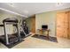 Home gym in basement with treadmill and elliptical at 30174 Glen Eyrie Dr, Evergreen, CO 80439