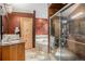 Bathroom with double sinks, soaking tub, and walk-in shower at 30174 Glen Eyrie Dr, Evergreen, CO 80439