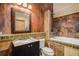 Bathroom with dark wood vanity and a built-in tub at 30174 Glen Eyrie Dr, Evergreen, CO 80439