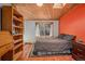 Bedroom with wooden floors, built-in shelves, and a double bed at 30174 Glen Eyrie Dr, Evergreen, CO 80439