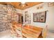 Charming dining room featuring a wooden table and a unique stone fireplace at 30174 Glen Eyrie Dr, Evergreen, CO 80439