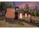 Stunning contemporary home exterior at dusk, showcasing warm lighting and mountain views at 30174 Glen Eyrie Dr, Evergreen, CO 80439