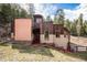 Contemporary mountain home with wood and stucco siding, nestled in a wooded setting at 30174 Glen Eyrie Dr, Evergreen, CO 80439