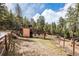 Exterior of home with wooden fence and mountain views at 30174 Glen Eyrie Dr, Evergreen, CO 80439