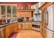 Modern kitchen with stainless steel appliances and wood cabinets at 30174 Glen Eyrie Dr, Evergreen, CO 80439