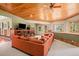 Bright living room with a sectional sofa, fireplace, and large windows offering forest views at 30174 Glen Eyrie Dr, Evergreen, CO 80439