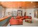 Living room with a cozy sectional sofa and views of the surrounding forest through large windows at 30174 Glen Eyrie Dr, Evergreen, CO 80439