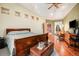 Main bedroom with king-size bed, hardwood floors, and sitting area at 30174 Glen Eyrie Dr, Evergreen, CO 80439