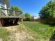 Spacious backyard featuring a wooden fence, deck, and lush greenery, perfect for outdoor activities and relaxation at 4824 S Eaton Park Way, Aurora, CO 80016