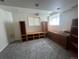Cozy basement featuring built-in wooden shelves and storage, with soft carpeting and bright lighting at 4824 S Eaton Park Way, Aurora, CO 80016