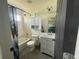 Well-lit bathroom with a shower-tub combo, a sink, and a colorful curtain for privacy at 4824 S Eaton Park Way, Aurora, CO 80016