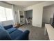 Bedroom area with blue couch and white bookshelf at 4824 S Eaton Park Way, Aurora, CO 80016
