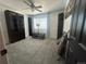 Carpeted bedroom with a ceiling fan, a window, and a wall-mounted bookcase for optimal storage at 4824 S Eaton Park Way, Aurora, CO 80016