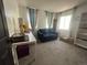 Bedroom area with blue couch and a white desk at 4824 S Eaton Park Way, Aurora, CO 80016
