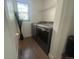 Laundry room with dark gray washer and dryer, and decorative window at 4824 S Eaton Park Way, Aurora, CO 80016