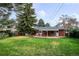 Spacious backyard with well-maintained lawn, mature trees, privacy fence, and covered patio at 6587 S Clarkson St, Centennial, CO 80121
