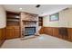 Finished basement with brick fireplace, wood paneling and custom built-ins at 6587 S Clarkson St, Centennial, CO 80121