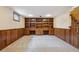 Finished basement featuring carpet, wood paneling, and built-in shelving at 6587 S Clarkson St, Centennial, CO 80121