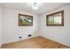 Bright bedroom with hardwood floors, two windows and overhead lighting at 6587 S Clarkson St, Centennial, CO 80121