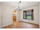 Elegant dining area with hardwood floors, a bay window, and modern lighting adjacent to the kitchen at 6587 S Clarkson St, Centennial, CO 80121