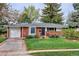 Inviting front yard with a brick walkway leading to a cozy brick home with an attached garage at 6587 S Clarkson St, Centennial, CO 80121
