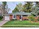 Charming single-story brick home featuring a well-manicured lawn and mature trees at 6587 S Clarkson St, Centennial, CO 80121