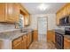 Traditional kitchen with wood cabinets, granite countertops, stainless steel appliances, and a window at 6587 S Clarkson St, Centennial, CO 80121