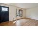 Cozy living area featuring a bay window and refinished hardwood floors, providing natural light at 6587 S Clarkson St, Centennial, CO 80121